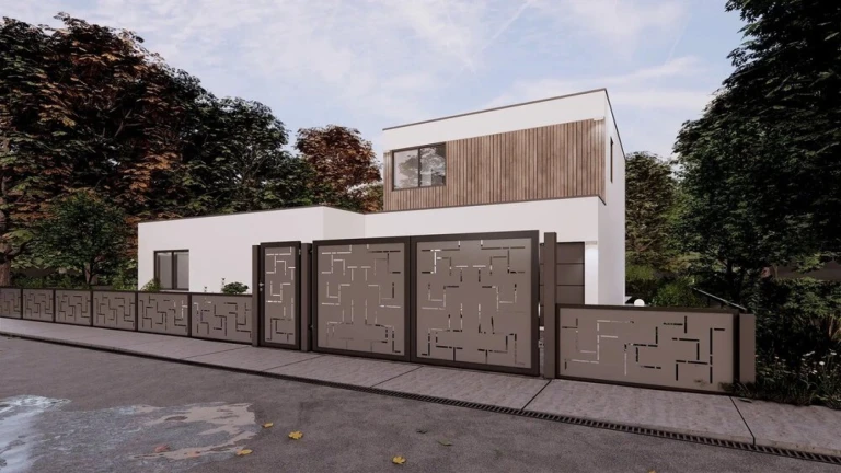 Maison familiale moderne dotée d'une clôture métallique décorative NARVI au motif géométrique.