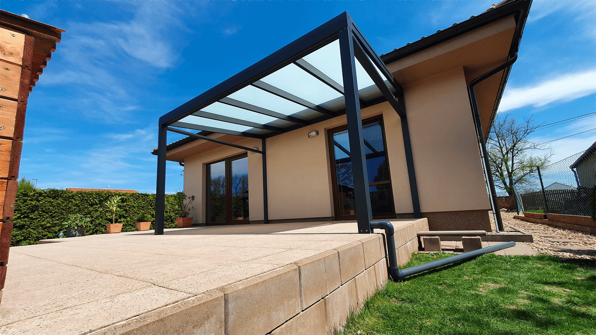Pergola moderne en aluminium anthracite avec toit vitré sur la terrasse d'une maison individuelle